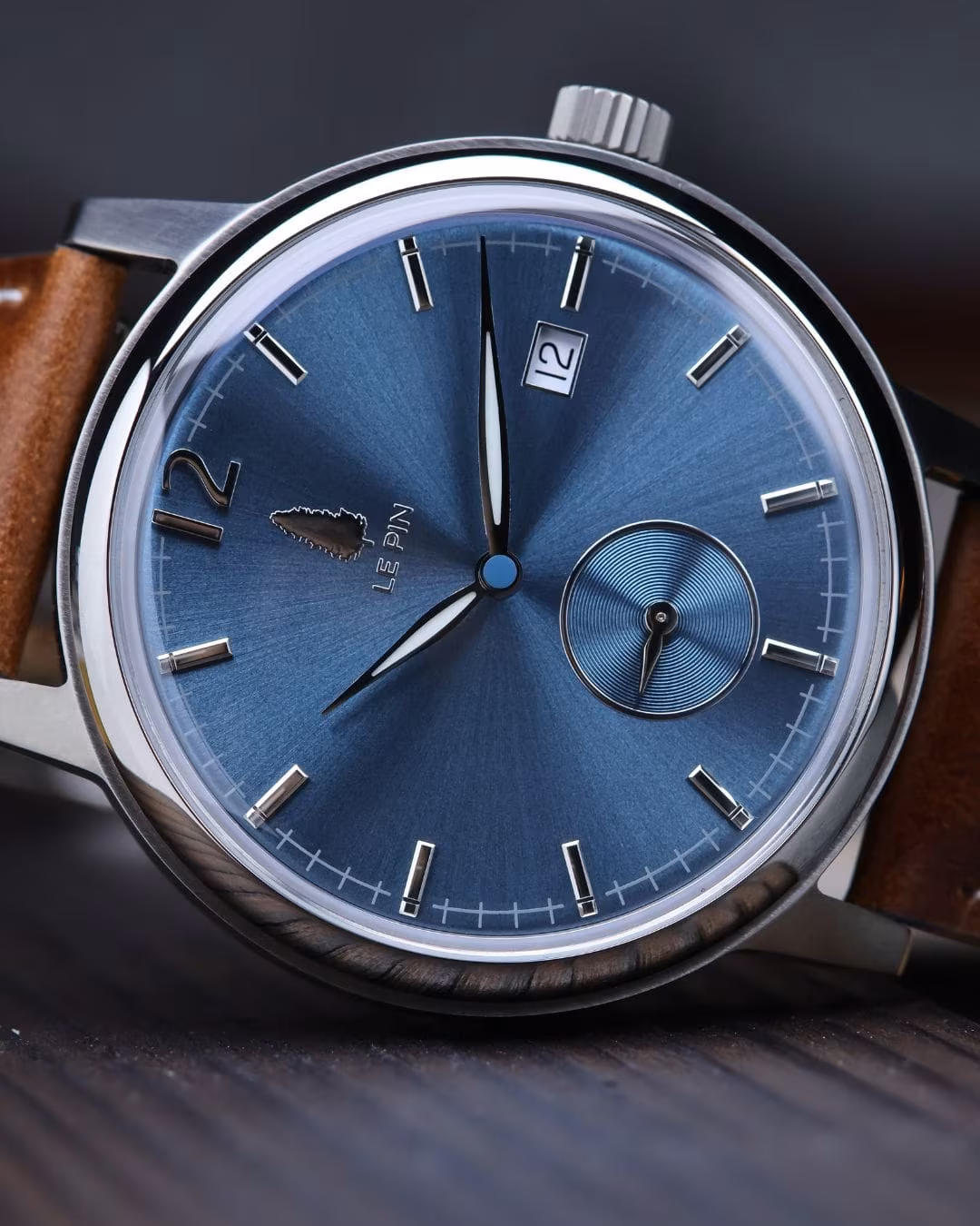 Angled view of the blue dial with the date window at three o'clock.
